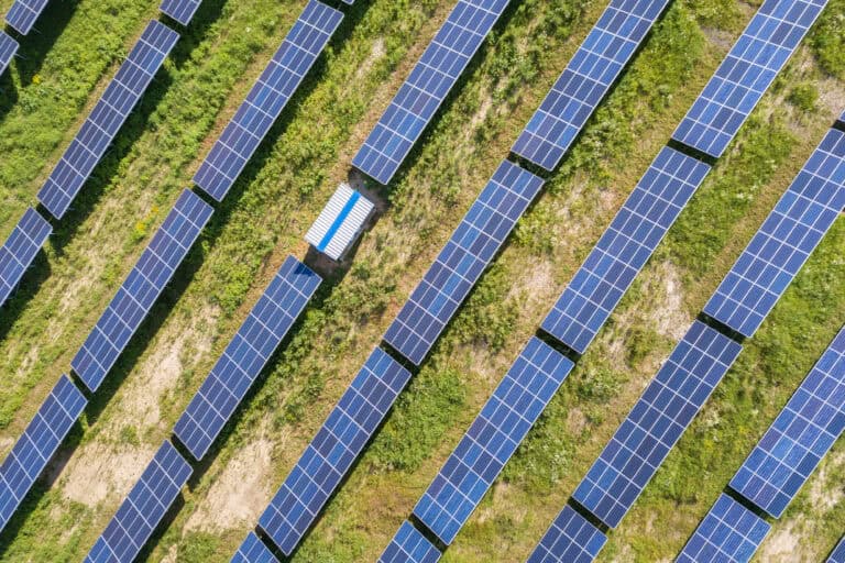 Aerial view of solar power plant on green field